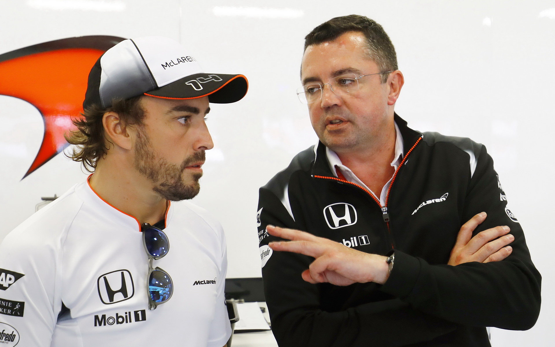 McLaren racing director Eric Boullier in talk with Fernando Alonso